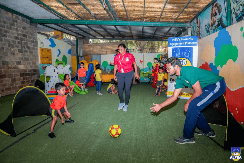 Go Alpha coaches in Pune engage preschoolers in an energetic soccer game, creating a fun and active learning environment.